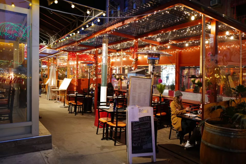 Italian restaurant outdoor dining patio with string lights in New York City